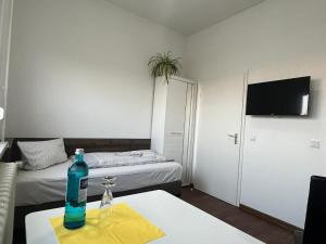 a room with a table with a bottle on it at Gästepension - Elsterland am Sport- und Freizeitpark in Elster