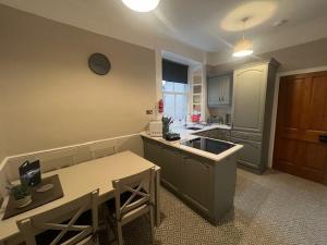 a kitchen with a sink and a counter top at The TEVIOT in the centre of Melrose in Melrose +9 photos