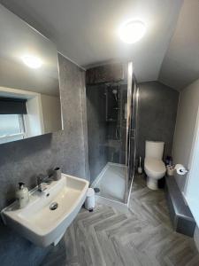 a bathroom with a sink and a shower and a toilet at The TEVIOT in the centre of Melrose in Melrose