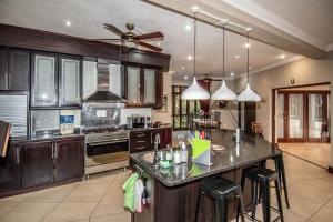 a kitchen with wooden cabinets and a large island at 7 Saint Andrew in White River