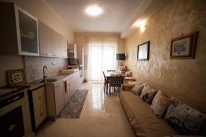 a living room with a couch and a kitchen at Duchessa Katia Accomodation Tropea in Tropea