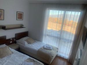 Ένα ή περισσότερα κρεβάτια σε δωμάτιο στο Privat apartment hotel Belvedere****