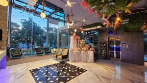 a wedding reception in a building with a table with flowers at BlueTel Re'sidencE Bangkok IMPACT - 1 Time Drop-Off Service to Impact in Nonthaburi +291 photos