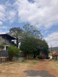 a house with a tree in front of it at Suíte em casa ampla e confortável in Araxá