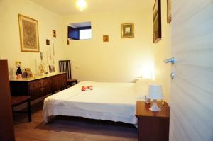 a bedroom with a bed and a table and a window at La Campagna del Benessere in Gildone