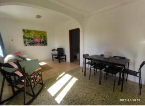 a living room with a dining room table and chairs at Country House Silves in Silves