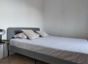 a bed with white sheets and pillows on it at Country House Silves in Silves
