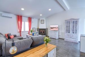 a living room with a couch and a fireplace at Casa al Mar in Maspalomas