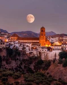 a view of a city with a moon in the sky at Casita Molino de Erillas in Alora +31 photos