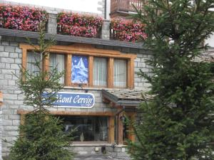 a stone building with a sign for a restaurant at Chambres Mont Cervin in Breuil-Cervinia