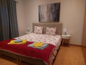 a bedroom with a bed with two towels on it at Casa da Oliveira in Mondim de Basto