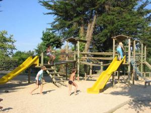 a group of people playing on a playground at Camping 4 étoiles - Parc aquatique - efcia0 in Soullans