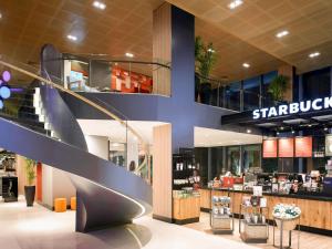 a store with a spiral staircase in a shopping mall at Ibis Saigon Airport in Ho Chi Minh City
