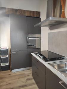 a kitchen with a stove and a sink at Trilocale con vista La Grandze Cir164 in La Salle +9 photos
