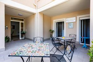 a patio with two tables and two chairs at Suite Tropea in Tropea