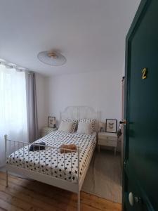a bedroom with a white bed and a window at Chambres cosy au coeur du village in Chaumont-en-Vexin +21 photos