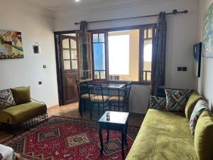 a living room with a couch and a table at Vu sur corniche in Safi