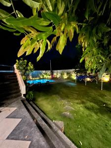 a night view of a park with a bench at JLR Farm Stay in Hyderabad