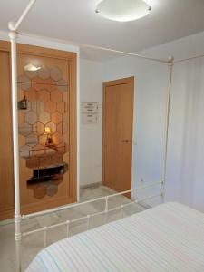 a bedroom with a bed and a glass wall at Apartamento Mirasol con parking privado in Fuengirola +13 photos