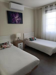 a bedroom with two beds and a window with a window at Mogan Sol in Puerto de Mogán +69 photos