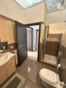 a bathroom with a toilet and a sink at Marconi e Garibaldi 76 apartment in Castellammare del Golfo