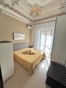 a bedroom with a bed and a coffered ceiling at Marconi e Garibaldi 76 apartment in Castellammare del Golfo