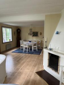 a living room with a table and a fireplace at Romantic Villa in historic setting with lake view in Säffle +18 photos