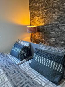 a bedroom with two beds with pillows and a lamp at OneRoom in Ohrid +20 photos