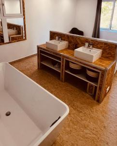 a bathroom with two sinks and a large tub at Bergerie Ceccu in Calvi +23 photos