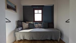 a bed in a room with a window at Jera Pince és Vendégház in Somlóvásárhely