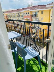 a balcony with a table and chairs and a building at Arezzo Place Davao - Condo Rentals WITH FREE POOL, 200MBPS CONNECTION in Lanang +13 photos