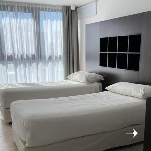 Postel nebo postele na pokoji v ubytování Temporal Suites