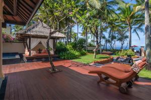 a resort patio with a gazebo and a chair at The St. Regis Bali Resort in Nusa Dua