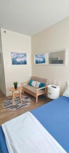 a living room with a bed and a couch at Condo in Silang near Nuvali - Dy's Haven Suites in Silang