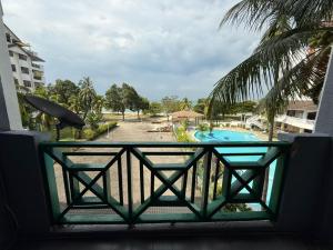 a balcony with a view of a swimming pool at Bayu Beach Resort Port Dickson Santai PD Homestay 2 Bedroom Apartment in Port Dickson