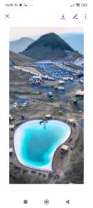 an image of a large blue lake on a beach at ΟΡΕΙΝΟ ΟΝΕΙΡΟ in Anilio Metsovo