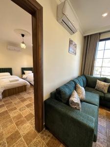 a living room with a couch and a bed at 12 Antica jabalal-lwebdeh in Amman