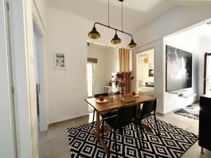 a dining room with a wooden table and chairs at Downtown apartment - Premium in Kamena Vourla