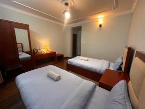 Voodi või voodid majutusasutuse Norbu Hotel toas
