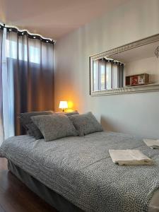 a bedroom with a large bed and a mirror at HALBY rooms Grzybowska 5 in Warsaw
