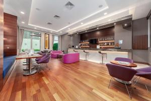 a restaurant with purple chairs and a bar at Park Dedeman Bostanci Hotel in Istanbul