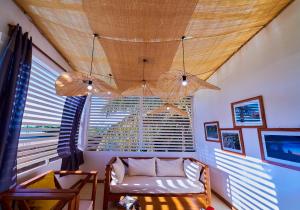 a living room with a couch and a large window at Chez Nounou in Diego Suarez