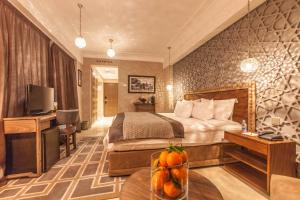 a hotel room with a bed and a television at Hivernage Hotel & Spa in Marrakesh