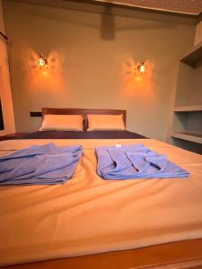 a bedroom with two towels on a bed at You and Me in Varkala