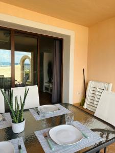 a dining room with a table with a plate on it at Apartment Gabriella in Muggia +8 photos