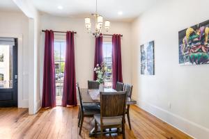 a dining room with a table and purple curtains at Private 3BR on Carondelet by Hosteeva in New Orleans +28 photos