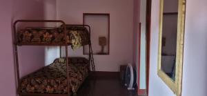 a bedroom with two bunk beds and a mirror at Rancho Grande in Santa María