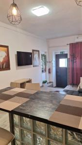 a living room with a table and a tv at Cantinho da Casa in Avis