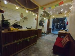 a restaurant with a counter and a window with lights at Milestone Homestay Agra in Tājganj