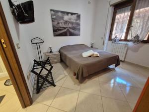 a bedroom with a bed and a television in it at Appia Antica Apartment in Rome